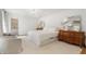 Airy main bedroom with chandelier, accent mirrors and ensuite bathroom entrance at 1305 Old Woodbine Rd, Atlanta, GA 30319