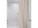 A bathtub and shower combination with a white shower curtain and tile backsplash at 1305 Old Woodbine Rd, Atlanta, GA 30319