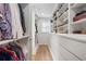Spacious walk-in closet with custom shelving, drawers, and a window at 1305 Old Woodbine Rd, Atlanta, GA 30319