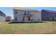 Backyard showcasing the home's rear exterior and covered patio at 2366 Cadenza Cir, Dacula, GA 30019