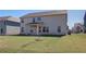 Spacious backyard with a partial view of the home's exterior and covered porch at 2366 Cadenza Cir, Dacula, GA 30019