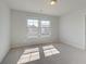 This bedroom features neutral carpeting, two large windows, and natural light at 2366 Cadenza Cir, Dacula, GA 30019
