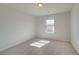 This bedroom features neutral carpeting, a large window, and natural light at 2366 Cadenza Cir, Dacula, GA 30019