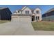 Beautiful two-story home with a large driveway and attached two-car garage at 2366 Cadenza Cir, Dacula, GA 30019