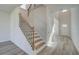 Open foyer with staircase, high ceilings, light wood floors, and natural light streaming in at 2366 Cadenza Cir, Dacula, GA 30019