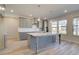 Kitchen features modern grey cabinets, white countertops, stainless steel appliances, and a center island at 2366 Cadenza Cir, Dacula, GA 30019