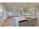 Kitchen island with sink and stainless-steel dishwasher overlooking the living room with a staircase at 2366 Cadenza Cir, Dacula, GA 30019
