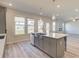 Kitchen island with stainless steel sink and white countertop overlooking the living room at 2366 Cadenza Cir, Dacula, GA 30019