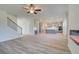 Open-concept living room and kitchen area with hardwood floors and modern grey cabinets at 2366 Cadenza Cir, Dacula, GA 30019