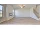 Modern living room with fireplace, hardwood floors, staircase, and large windows at 2366 Cadenza Cir, Dacula, GA 30019