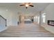 Spacious living area with luxury vinyl plank flooring, electric fireplace, and adjacent open kitchen at 2366 Cadenza Cir, Dacula, GA 30019