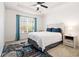 Bedroom with a ceiling fan, side table, and view to the outside at 4435 Bellwood Cir, Atlanta, GA 30349