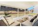 Stylish covered patio features cozy seating around a modern fire pit and lovely backyard views at 4435 Bellwood Cir, Atlanta, GA 30349