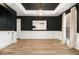 Elegant dining room featuring dark accent walls, modern lighting, and bright hardwood flooring at 4435 Bellwood Cir, Atlanta, GA 30349