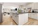 Spacious kitchen with center island, white cabinetry, and hardwood flooring at 4435 Bellwood Cir, Atlanta, GA 30349