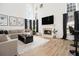 Bright living room with fireplace, wood floors, large windows and modern decor at 4435 Bellwood Cir, Atlanta, GA 30349
