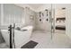 Bright main bathroom with a freestanding tub, glass shower enclosure, tiled floor, and a large window at 4435 Bellwood Cir, Atlanta, GA 30349
