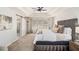 Bright main bedroom featuring tray ceilings, a king bed, a carpeted floor, and a doorway to the bath at 4435 Bellwood Cir, Atlanta, GA 30349