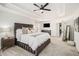 Bright main bedroom featuring tray ceilings, a ceiling fan, a king bed, and a carpeted floor at 4435 Bellwood Cir, Atlanta, GA 30349