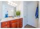 Bathroom with wood cabinets, a large mirror, and neutral flooring and fixtures at 2145 Shoop Se Ct # 3, Smyrna, GA 30080