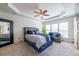 Bedroom featuring tray ceilings, ceiling fan, and large windows with natural light at 2145 Shoop Se Ct # 3, Smyrna, GA 30080