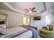 Bedroom featuring a ceiling fan, ensuite doors, a television, and a sitting area at 2145 Shoop Se Ct # 3, Smyrna, GA 30080