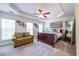 Bright bedroom with tray ceiling, ceiling fan, sitting area, and dark wood sleigh bed at 2145 Shoop Se Ct # 3, Smyrna, GA 30080