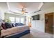 Bright bedroom with tray ceiling, ceiling fan, and wall-mounted TV at 2145 Shoop Se Ct # 3, Smyrna, GA 30080