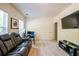 Bonus room featuring a large screen television, a modern sofa, and bright windows at 2145 Shoop Se Ct # 3, Smyrna, GA 30080