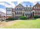 Attractive multi-story townhome with a brick facade, shutters, manicured lawn, and a welcoming entrance at 2145 Shoop Se Ct # 3, Smyrna, GA 30080