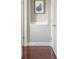 Hallway with hardwood flooring, white trim and neutral wall paint at 2145 Shoop Se Ct # 3, Smyrna, GA 30080