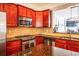 Gourmet kitchen featuring stainless steel appliances, dark granite countertops, and stylish backsplash at 2145 Shoop Se Ct # 3, Smyrna, GA 30080