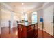 Kitchen island and dining area feature granite countertops and natural light streaming through arched windows at 2145 Shoop Se Ct # 3, Smyrna, GA 30080