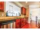 Well-appointed kitchen with granite countertops and stainless steel dishwasher and rich hardwood floors at 2145 Shoop Se Ct # 3, Smyrna, GA 30080