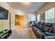 Comfortable living room with a black leather sofa and natural light from the window at 2145 Shoop Se Ct # 3, Smyrna, GA 30080