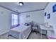 Bright bedroom featuring a comfy bed, desk area, and natural light from the window at 2477 Lakebrooke Dr, Marietta, GA 30066