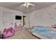 Bright bedroom featuring cute unicorn wall decor, a comfy beanbag chair, and a ceiling fan at 2477 Lakebrooke Dr, Marietta, GA 30066