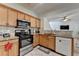 Modern kitchen with stainless steel appliances, wood cabinetry, and granite countertops at 2477 Lakebrooke Dr, Marietta, GA 30066