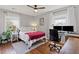 Bright bedroom with hardwood floors, ceiling fan, and a work space with dual monitors at 542 Goldsboro Ne Rd # C, Atlanta, GA 30307