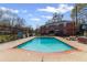 Inviting community pool surrounded by trees, a fence and a sun deck, offering a great outdoor retreat at 542 Goldsboro Ne Rd # C, Atlanta, GA 30307