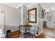 Cozy entryway with hardwood floors, a dining set, and view into a modern kitchen at 542 Goldsboro Ne Rd # C, Atlanta, GA 30307