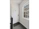 Entryway featuring a white door, window with natural light and neutral carpet at 542 Goldsboro Ne Rd # C, Atlanta, GA 30307