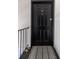 Stylish black front door with a striped welcome mat and black metal railing at 542 Goldsboro Ne Rd # C, Atlanta, GA 30307