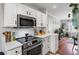 Modern kitchen features stainless steel appliances, white cabinets, and trendy accents, enhancing the home's appeal at 542 Goldsboro Ne Rd # C, Atlanta, GA 30307