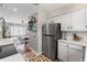 Open-concept kitchen featuring stainless steel appliances and seamless transition to the adjacent living and dining areas at 542 Goldsboro Ne Rd # C, Atlanta, GA 30307