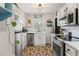 Charming kitchen featuring white cabinets, stainless steel appliances, and unique patterned flooring at 542 Goldsboro Ne Rd # C, Atlanta, GA 30307