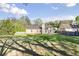 Backyard view of the home featuring a patio and expansive lawn at 1222 W Wylie Bridge Rd, Woodstock, GA 30188