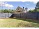 Fenced backyard with plenty of green space and mature trees at 1222 W Wylie Bridge Rd, Woodstock, GA 30188