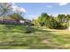 Large grassy backyard with trees and a privacy fence at 1222 W Wylie Bridge Rd, Woodstock, GA 30188