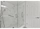 Bathroom featuring walk-in shower with glass doors and grab bars at 1222 W Wylie Bridge Rd, Woodstock, GA 30188